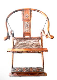 HUANGHUALI FOLDING HORSESHOE-BACK ARMCHAIR, JIAOYI: HUANGHUALI FOLDING HORSESHOE-BACK ARMCHAIR, JIAOYI Of classic Ming-style design, the chair features a sweeping horseshoe-shaped crestrail supported on shaped arms with ruyi-form terminals, joined by m