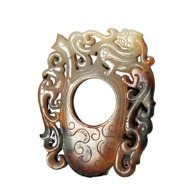 A CARVED AND RETICULATED JADE ARCHER RING SHE