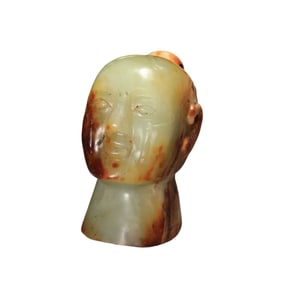 A JADE CARVING OF FIGURE HEAD