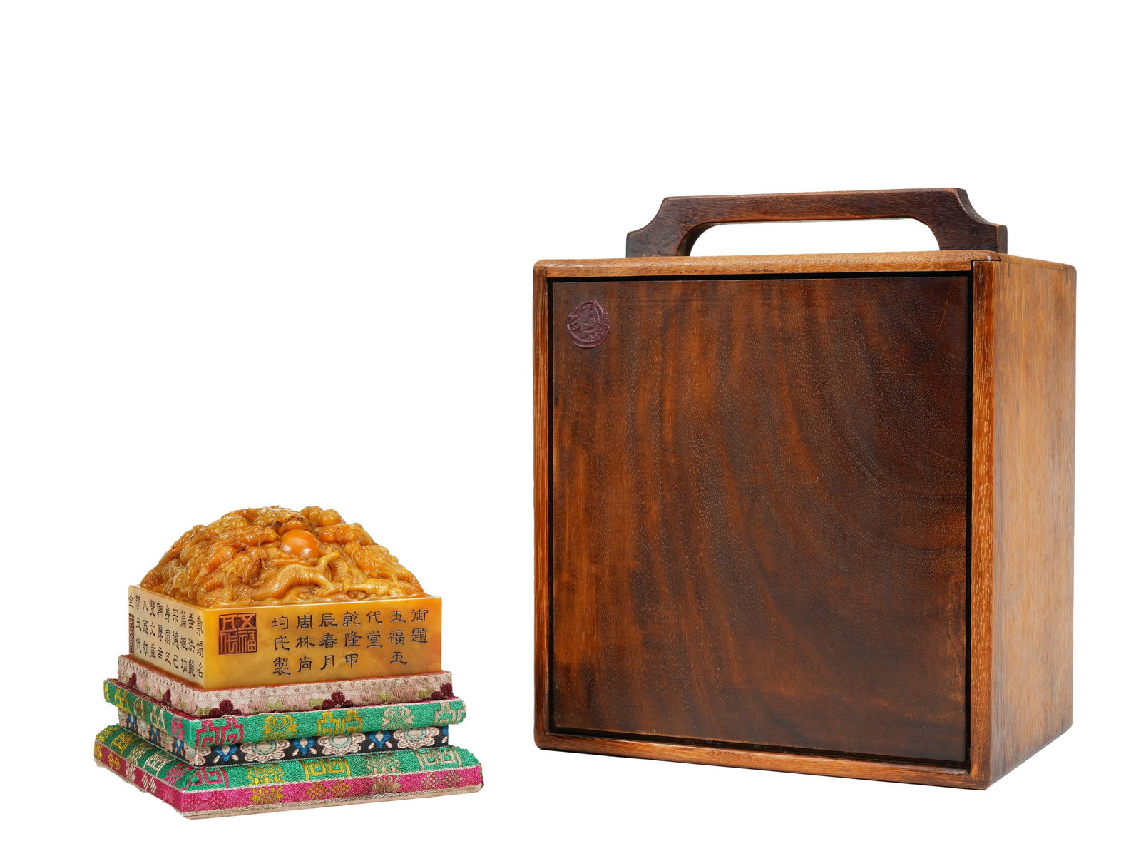 A FINE CARVED TIANHUANG DRAGONS SEAL: A FINE CARVED TIANHUANG DRAGONS SEAL Of squared shape, finely carved dragons group chasing flaming pearl as finial, inscirbed at the sides, the stone is of rich amber tone with matched box. DIMENSION: