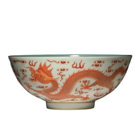 A CHINESE IRON RED AND GILT DRAGONS BOWL
