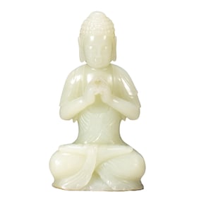 A CARVED WHITE JADE MAHAVAIROCANA
