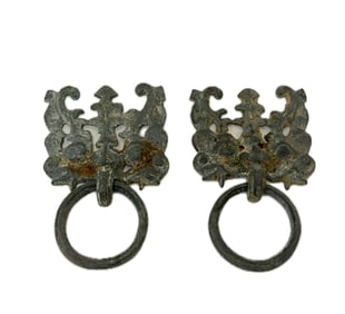 A BRONZE TAOTIE MASK WITH A RING HANDLE