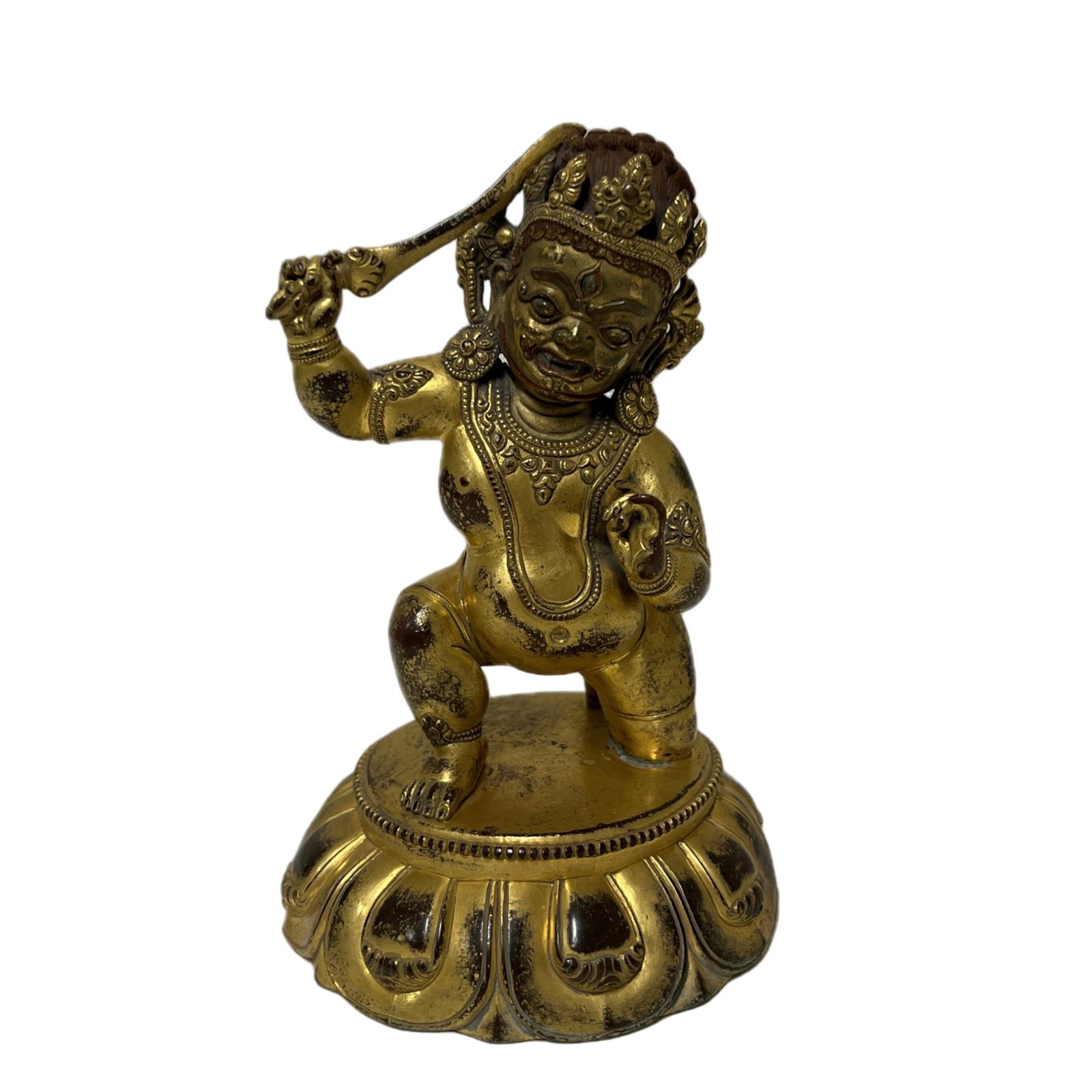 A BRONZE GILT VAJRAPANI: A BRONZE GILT VAJRAPANI The wrathful or yidam tutelary deity stands in a powerful lunge, or alidhasana, on a lotus base, his right hand brandishing a vajra, the left in tarjani mudra. Vajrapani, origi