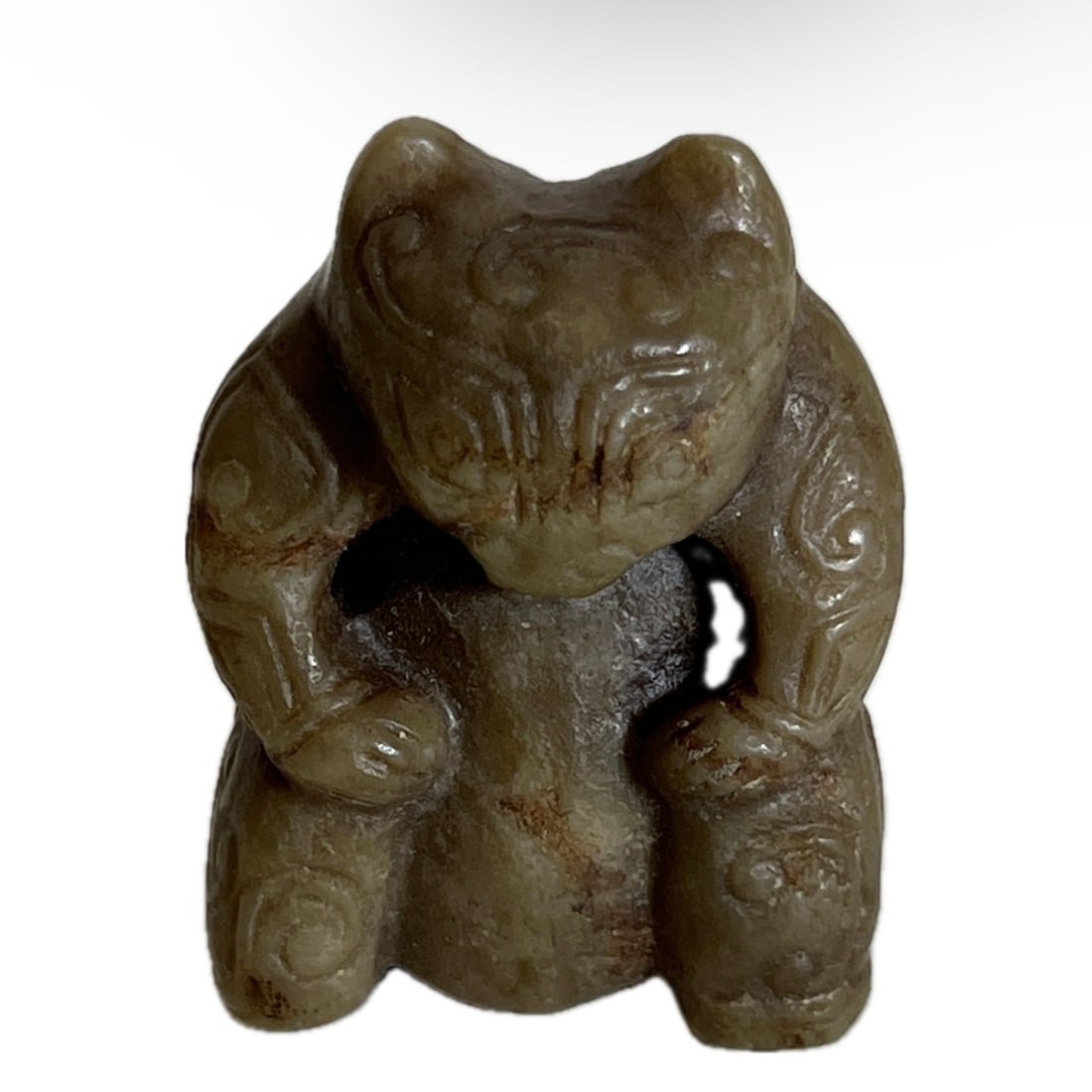 A CARVED JADE BEAR: A CARVED JADE BEAR Carved in round, incised with archaistic patterns at the exterior. FROM NEW YORK COLLECTOR. DIMENSION: H. 5 cm. A LIST OF RECOMMENDED THIRD-PARTY SHIPPER IS AVAILABLE UNDER