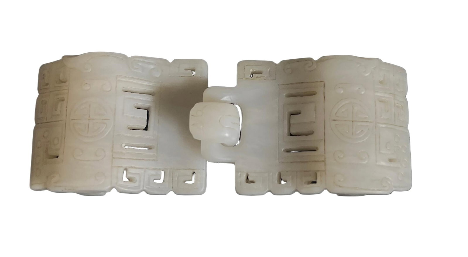 A CARVED WHITE JADE BELTHOOK: A CARVED WHITE JADE BELTHOOK Finely carved, decorated with archaistic patterns. FROM NEW YORK COLLECTOR. DIMENSION: L. 11 cm. W. 4 cm. A LIST OF RECOMMENDED THIRD-PARTY SHIPPER IS AVAILABLE UNDER SHIP