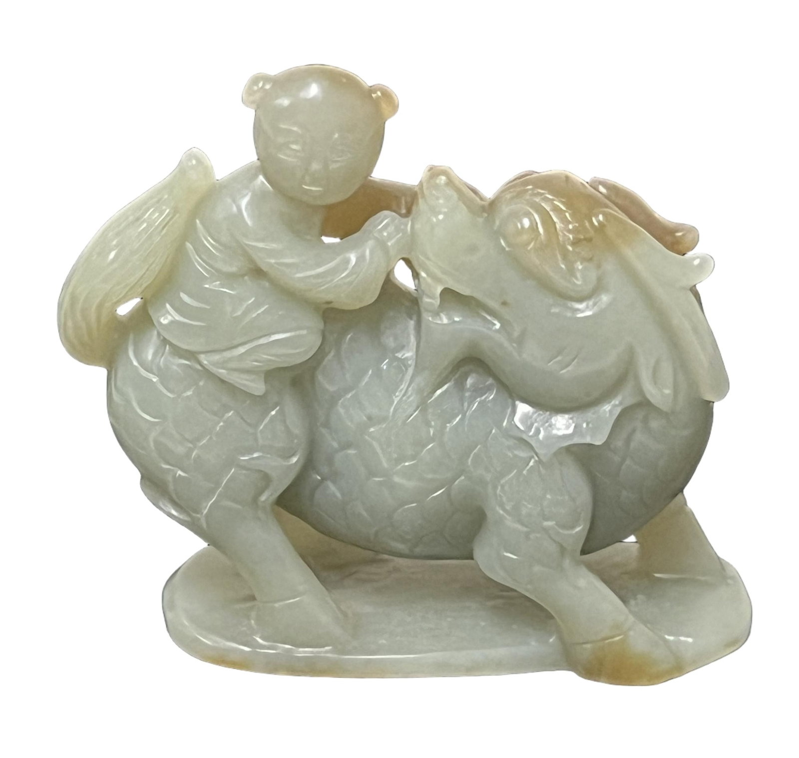 A CARVED JADEITE KYLIN WITH BOY: A CARVED JADEITE KYLIN WITH BOY The stone is of pale tone with russet skins. DIMENSION: H. 7 cm. L. 8 cm. A LIST OF RECOMMENDED THIRD-PARTY SHIPPER IS AVAILABLE UNDER SHIPPING INFORMATION. PLEASE FEEL