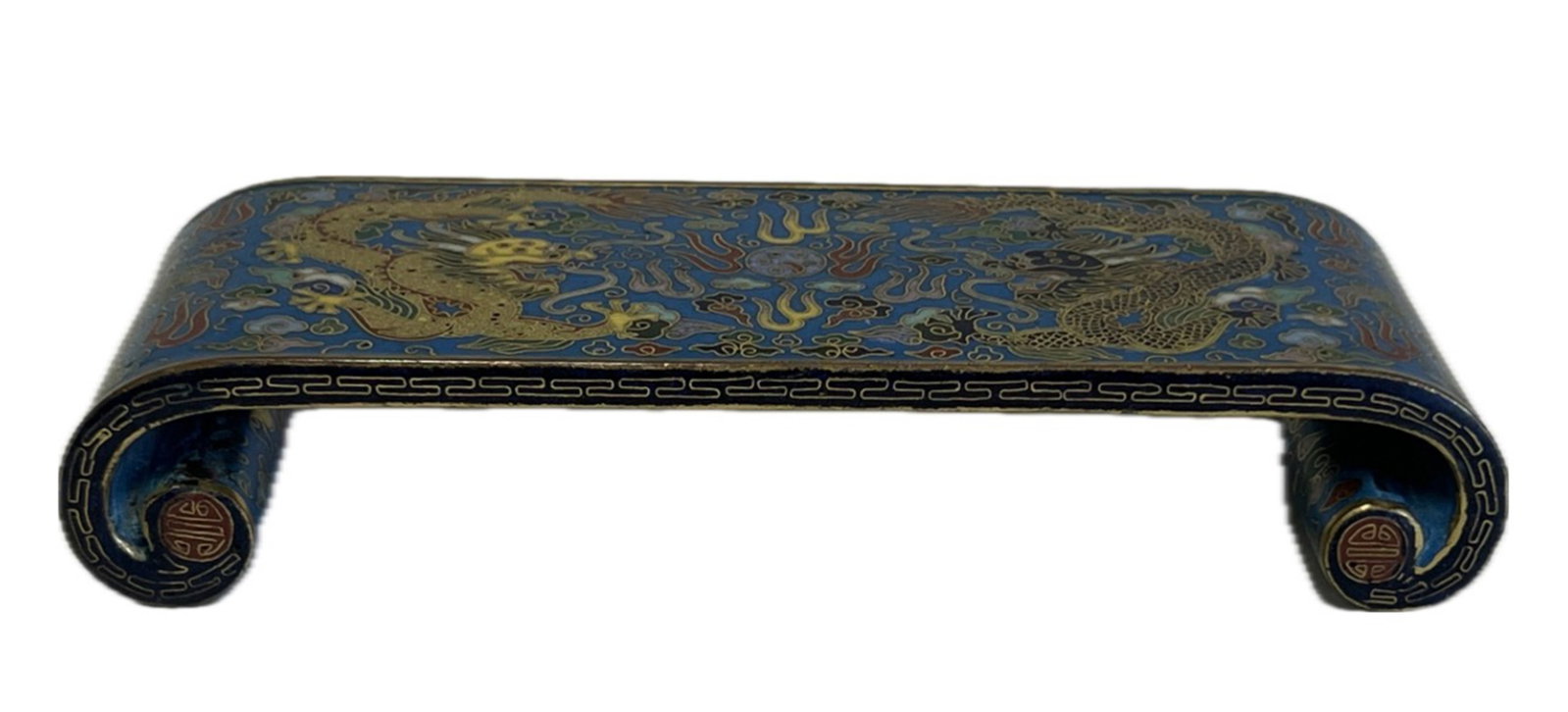 A CLOISONNE ENAMEL LOW TEBLE: A CLOISONNE ENAMEL LOW TEBLE Decorated with dragons chasing flaming pearl against turquoise ground. DIMENSION: L. 15.5 cm. W. 6 cm. H. 3 cm. A LIST OF RECOMMENDED THIRD-PARTY SHIPPER IS AVAILABLE