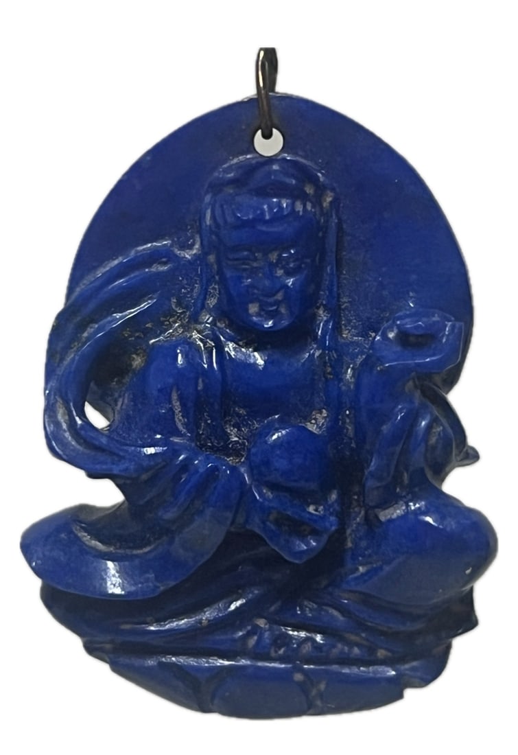 A CARVED LAPIS GUANYIN PENDANT: A CARVED LAPIS GUANYIN PENDANT Carved by lapis, the seated deity with seven expression on face. DIMENSION: A LIST OF RECOMMENDED THIRD-PARTY SHIPPER IS AVAILABLE UNDER SHIPPING INFORMATION. PLEASE