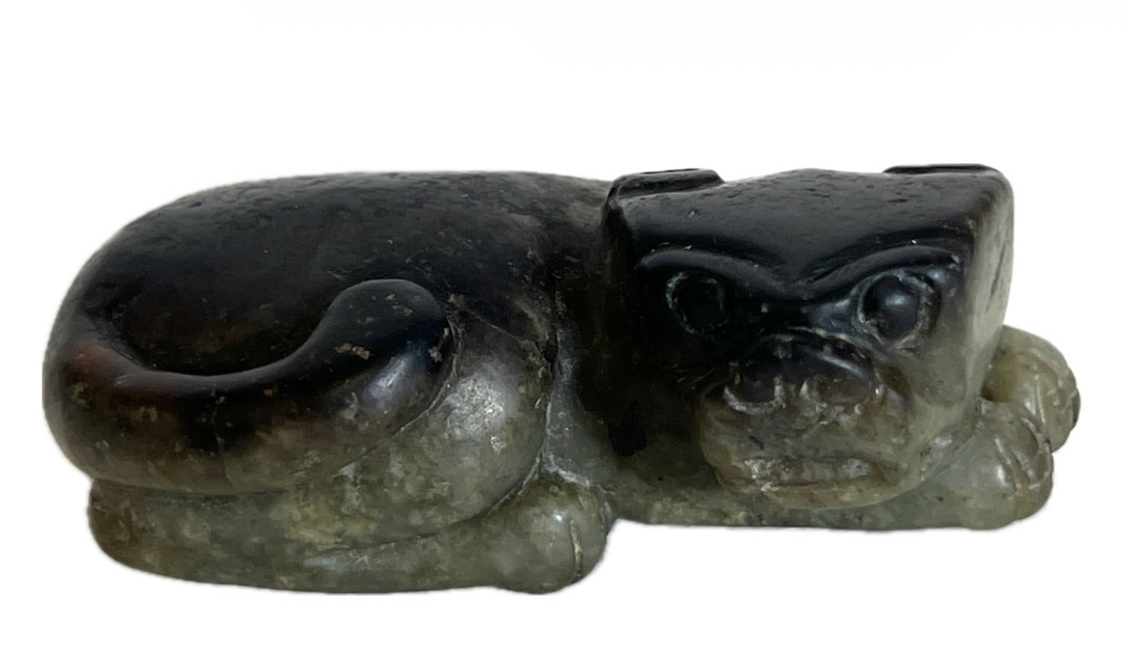 A CARVED JADE BEAST: A CARVED JADE BEAST Carved recumbent beast, the stone is of half celadon half russet tone. FROM NEW YORK COLLECTOR. DIMENSION: A LIST OF RECOMMENDED THIRD-PARTY SHIPPER IS AVAILABLE UNDER SHIPPING