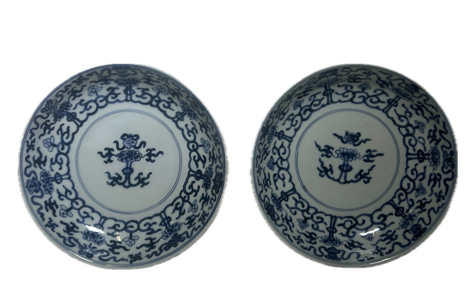 PAIR BLUE AND WHITE LOTUS PLATES: PAIR BLUE AND WHITE LOTUS PLATES Painted with lotus sprays at the interior in cobalt blue. DIMENSION: Caliber. 20 cm. A LIST OF RECOMMENDED THIRD-PARTY SHIPPER IS AVAILABLE UNDER SHIPPING