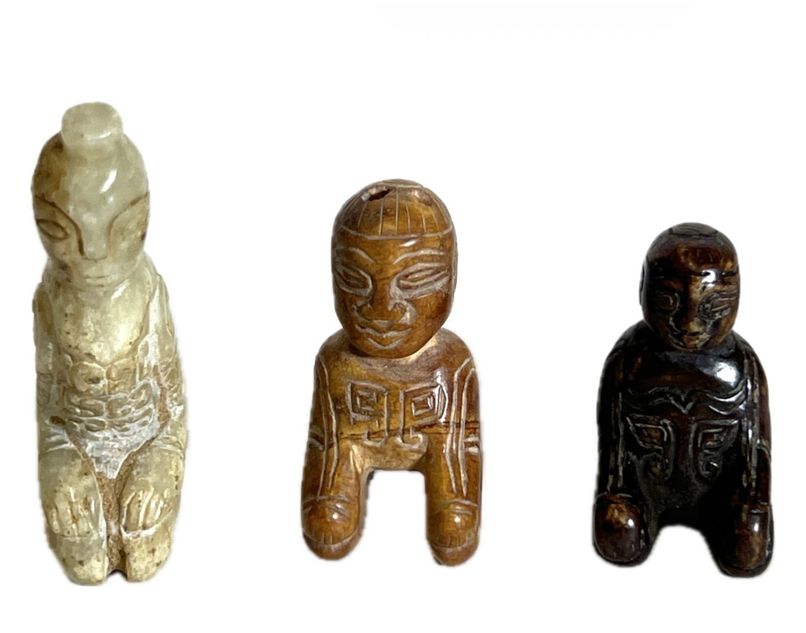 THREE CARVED JADE KNEELING FIGURES (1 of 8)