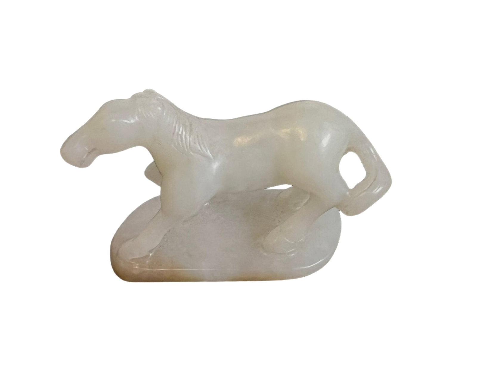 A CARVED WHITE JADE HORSE: A CARVED WHITE JADE HORSE Carved with round horse, the stone is of white tone with russet skins. FROM NEW YORK COLLECTOR. DIMENSION: L. 6 cm. W. 2.5 H. 4 cm. A LIST OF RECOMMENDED THIRD-PARTY SHIPPER 
