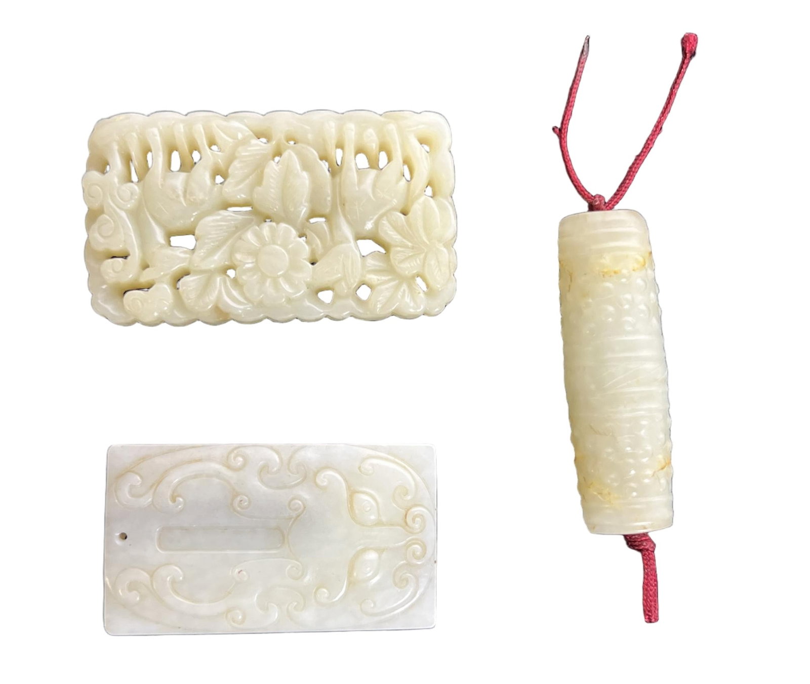 THREE CARVED WHITE JADE BEAD AND PLAQUES: THREE CARVED WHITE JADE BEAD AND PLAQUES In a number of three, the stone is of white tone. DIMENSION: L. 6 cm. W. 3.5 L. 6 cm. A LIST OF RECOMMENDED THIRD-PARTY SHIPPER IS AVAILABLE UNDER SHIPPING INF
