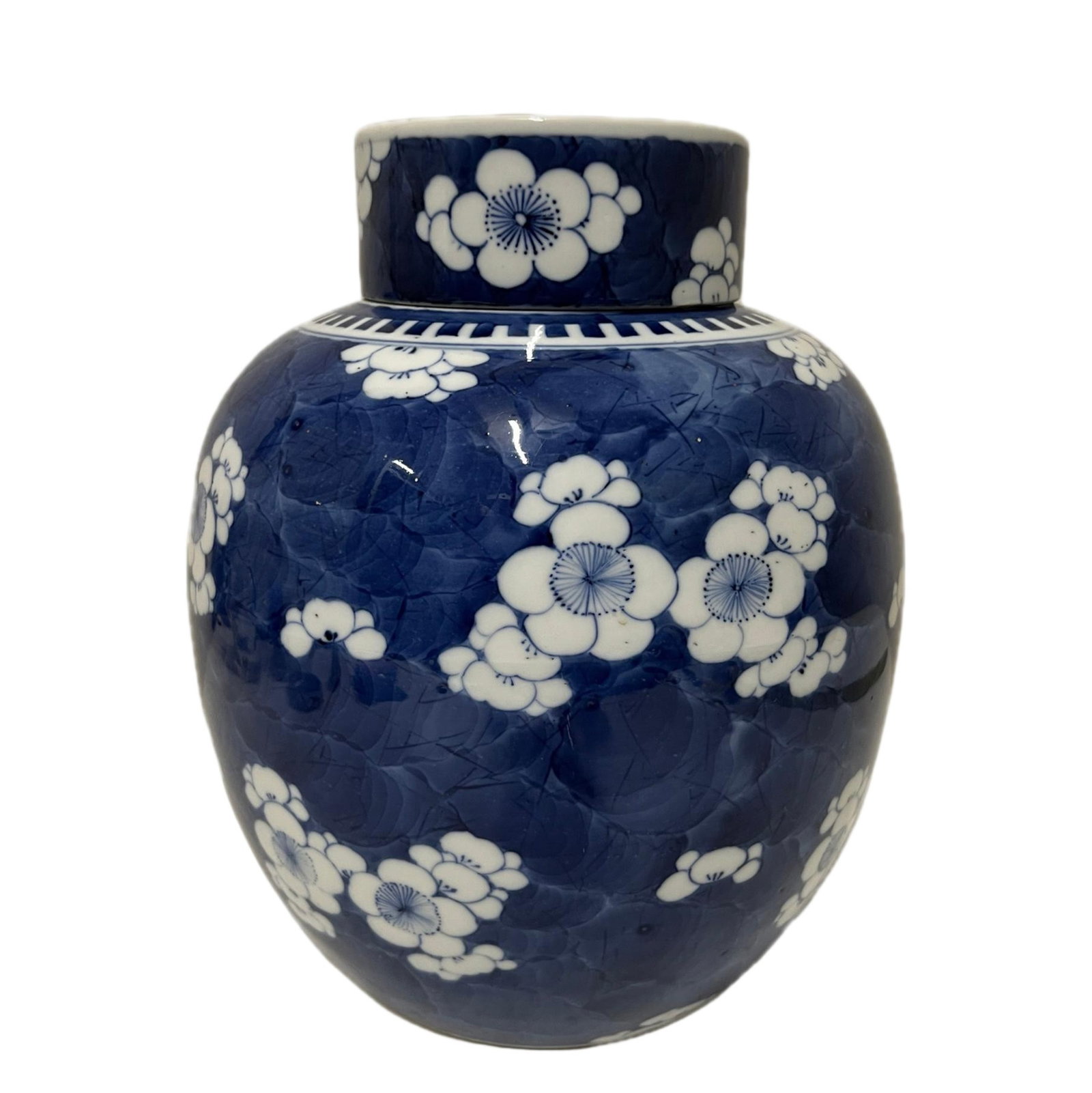 A BLUE AND WHITE PLUM BLOOMS JAR WITH COVER: A BLUE AND WHITE PLUM BLOOMS JAR WITH COVER Of blaster shape, decorated with plum blooms at the belly, surmounted with a dome cover. DIMENSION: H. 26 cm. A LIST OF RECOMMENDED THIRD-PARTY SHIPPER IS A