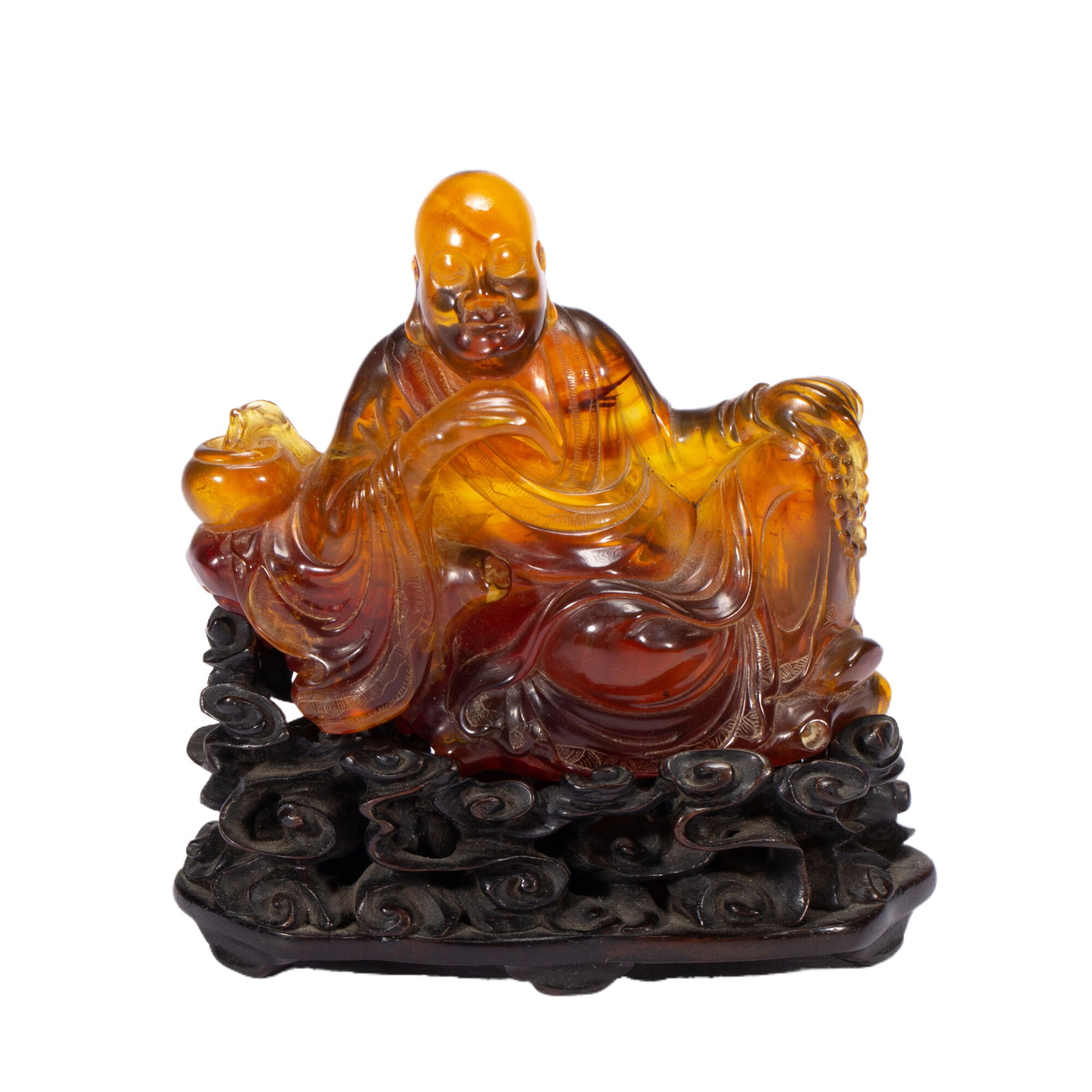 A CARVED AMBER LUOHAN: A CARVED AMBER LUOHAN The figure is carved with a naturalistic, benevolent expression, with his curly brows, mustache and beard rendered in undulating detail. He is carved wearing long, flowing robes