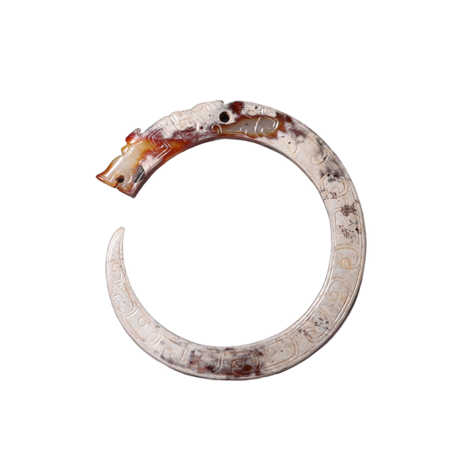 A CARVED JADE C-FORM DRAGON: A CARVED JADE C-FORM DRAGON Of typical 'C' shape with an arched body extending to a pointed tip at the tail, its head detailed with round eyes, incised with archaistic patterns at the body.