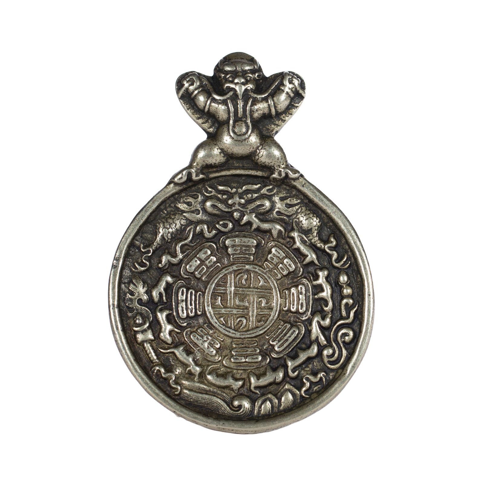 A TIBETAN SILVER AMULET PLAQUE: A TIBETAN SILVER AMULET PLAQUE The garuda surmounted atop of the pendant, with surface oxidize marks. DIMENSION: L. 7.5 cm. W. 5 cm. Weight 50 grams. A LIST OF RECOMMENDED THIRD-PARTY SHIPPER IS