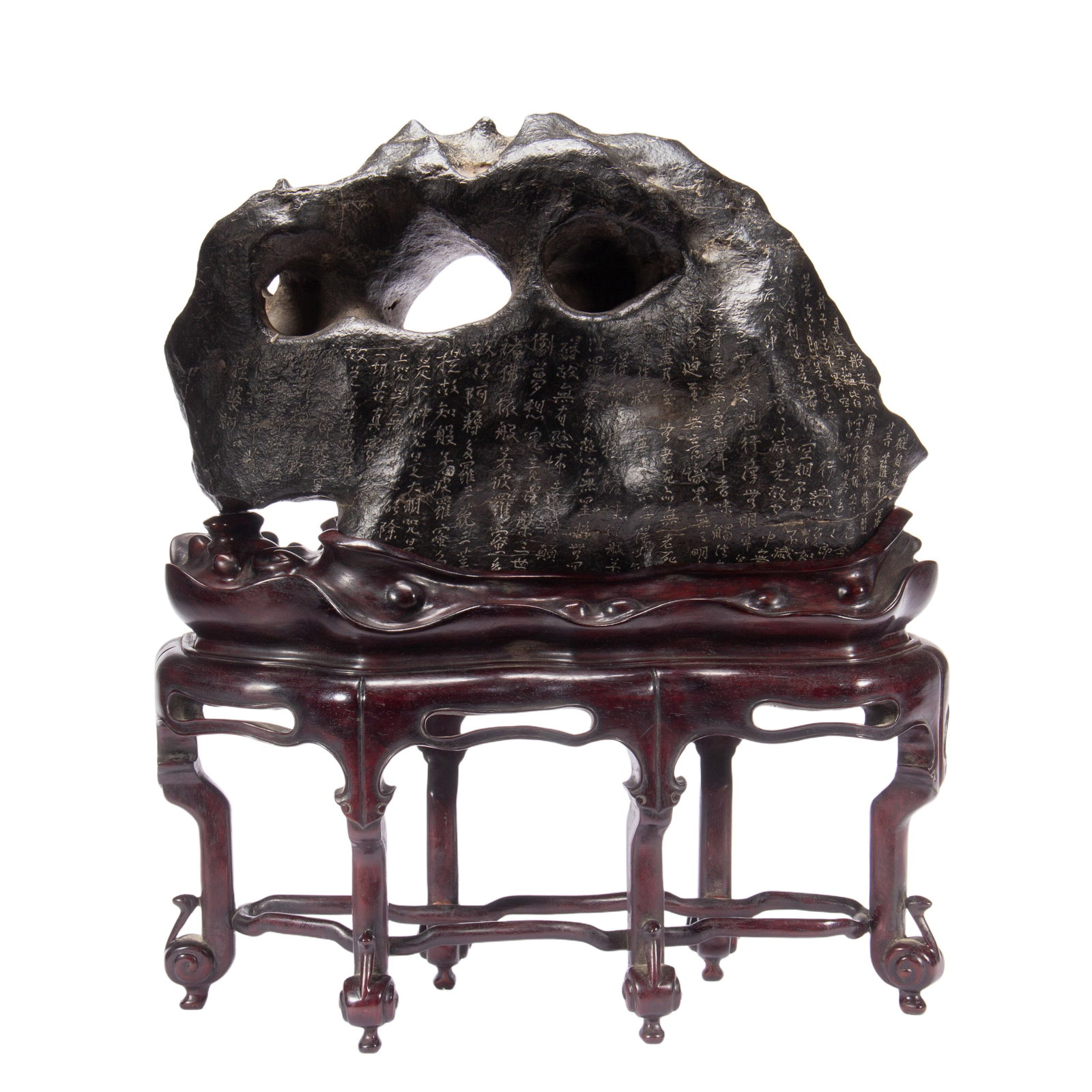 A CHINESE INSCRIBED LITERATI ROCK: A CHINESE INSCRIBED LITERATI ROCK The literati rock of irregular form, well polish with smooth textured, the natural stone in dark tone with russet skins, inscribed at the surface, fitted into a carve