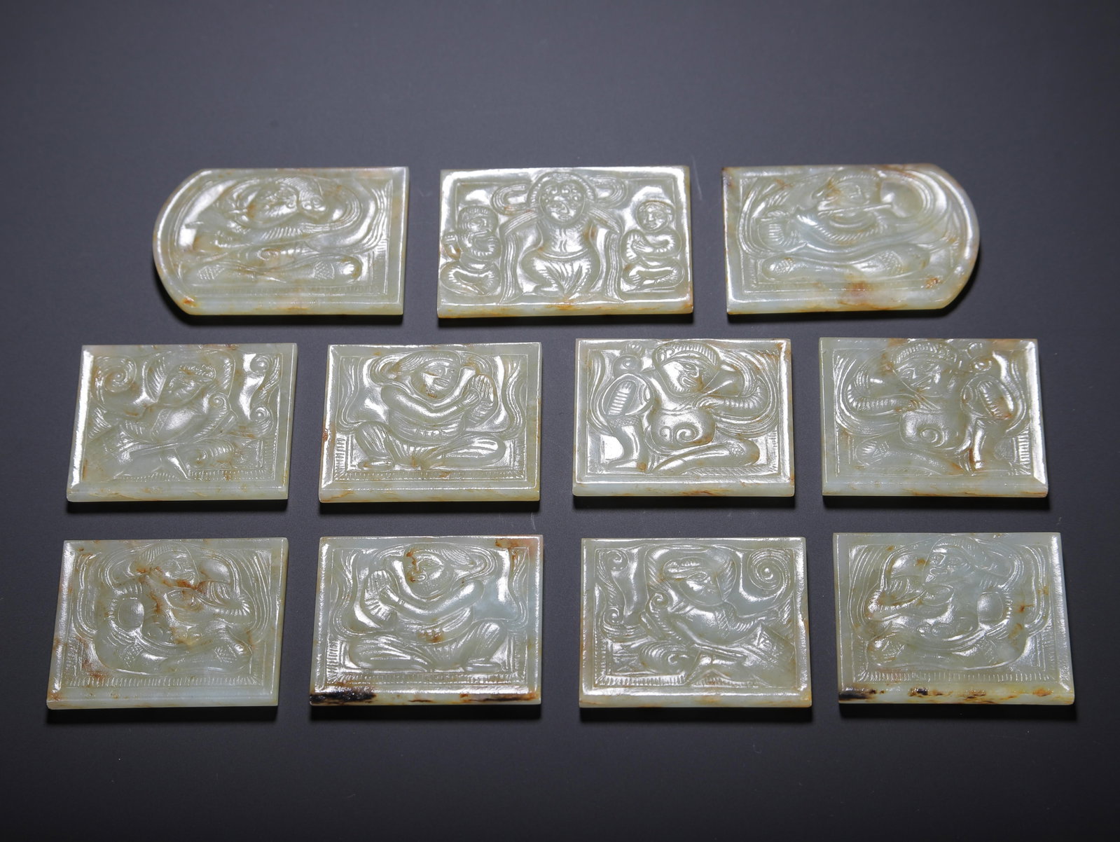A SET OF CARVED WHITE JADE BELT PLAQUES (1 of 9)