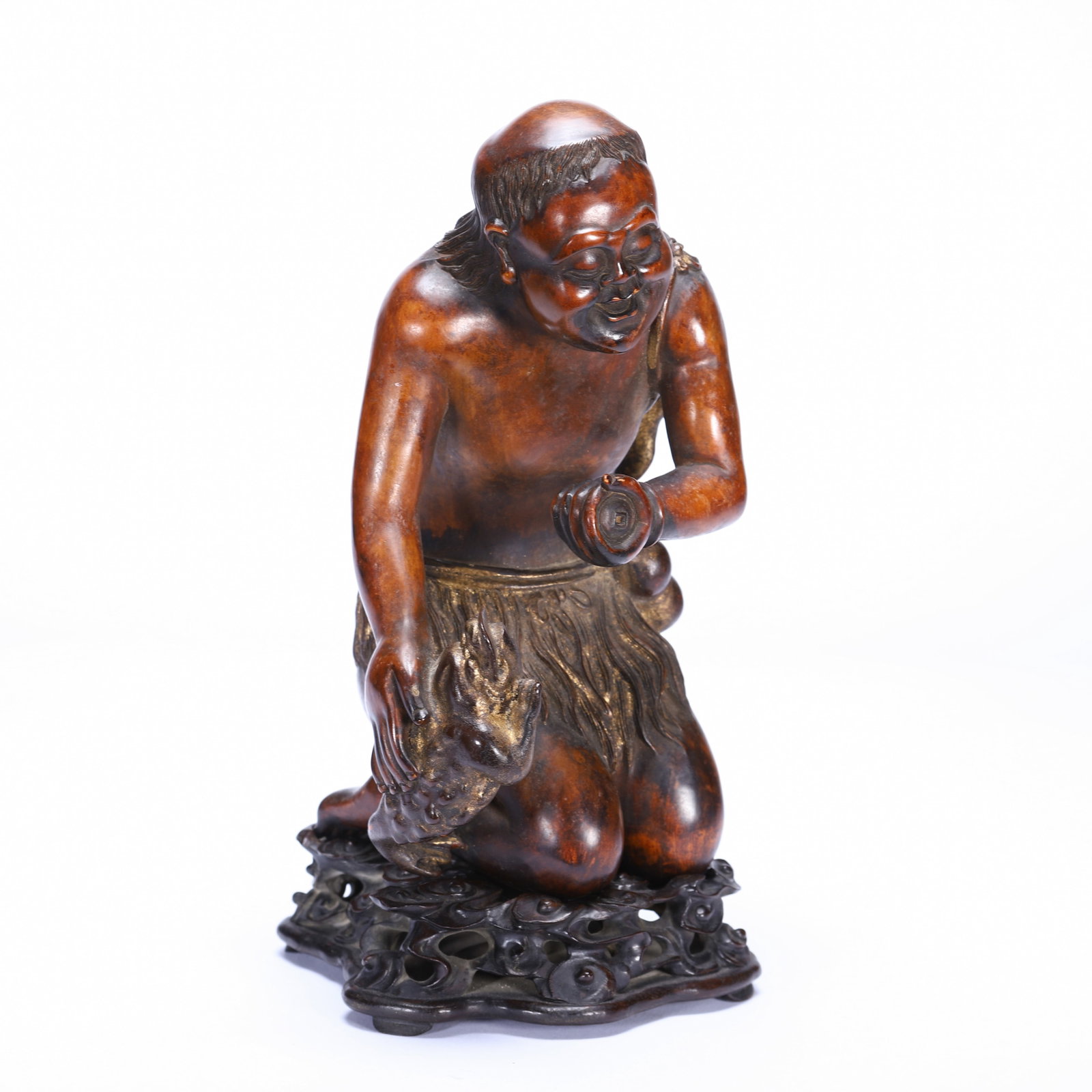 A CARVED BOXWOOD LIUHAI WITH GOLDEN FROG: A CARVED BOXWOOD LIUHAI WITH GOLDEN FROG Well carved in the round with the figure of Liuhai in a dynamic pose with his arms raised holding a string of cash coins, his right leg resting on a