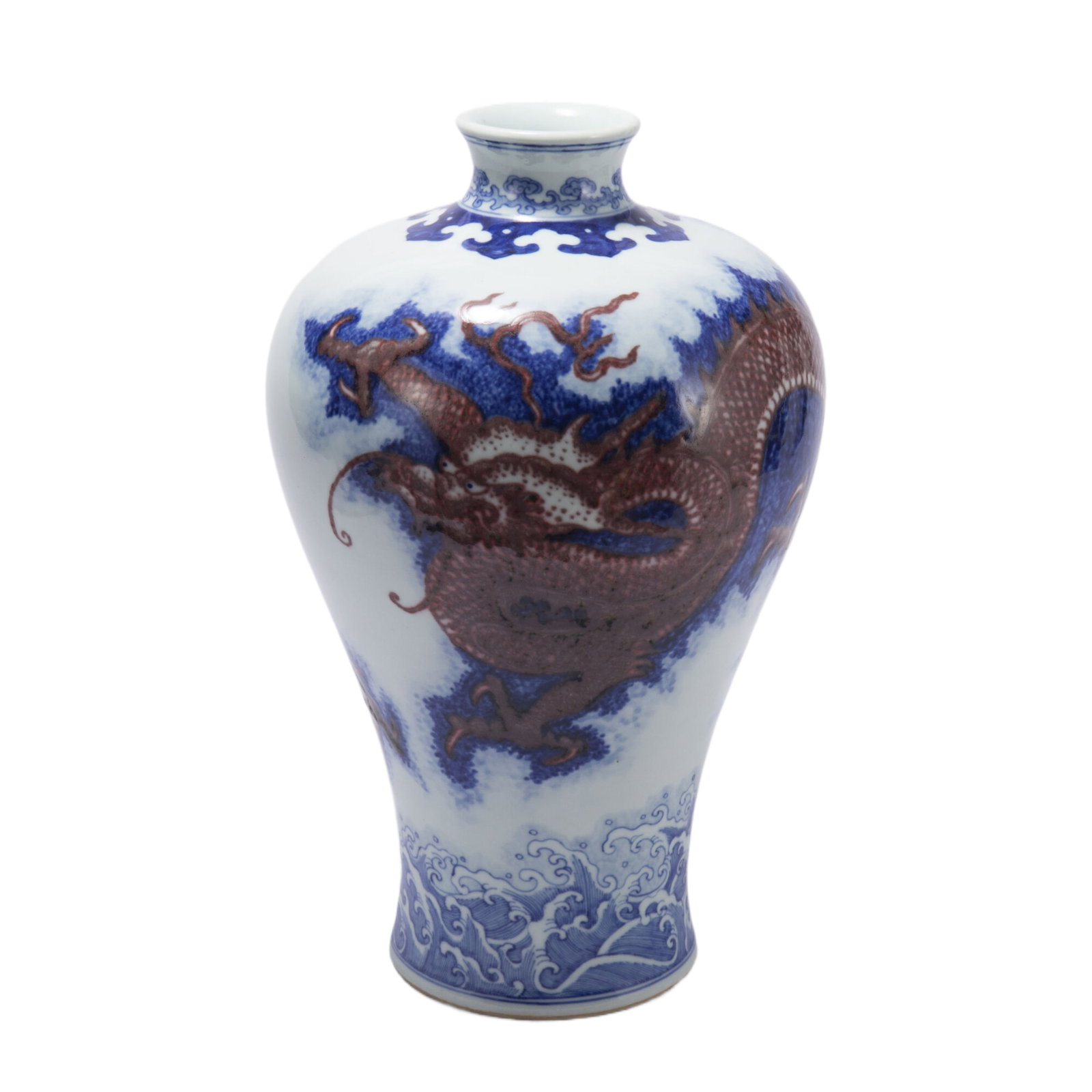 A CHINESE UNDERGLAZE BLUE AND COPPER RED PORCELAIN VASE MEIPING: A CHINESE UNDERGLAZE BLUE AND COPPER RED PORCELAIN VASE MEIPING Rising from a slightly splayed foot to a high-shoulder body blow a short, waisted neck, painted in three claws ferocious dragon in