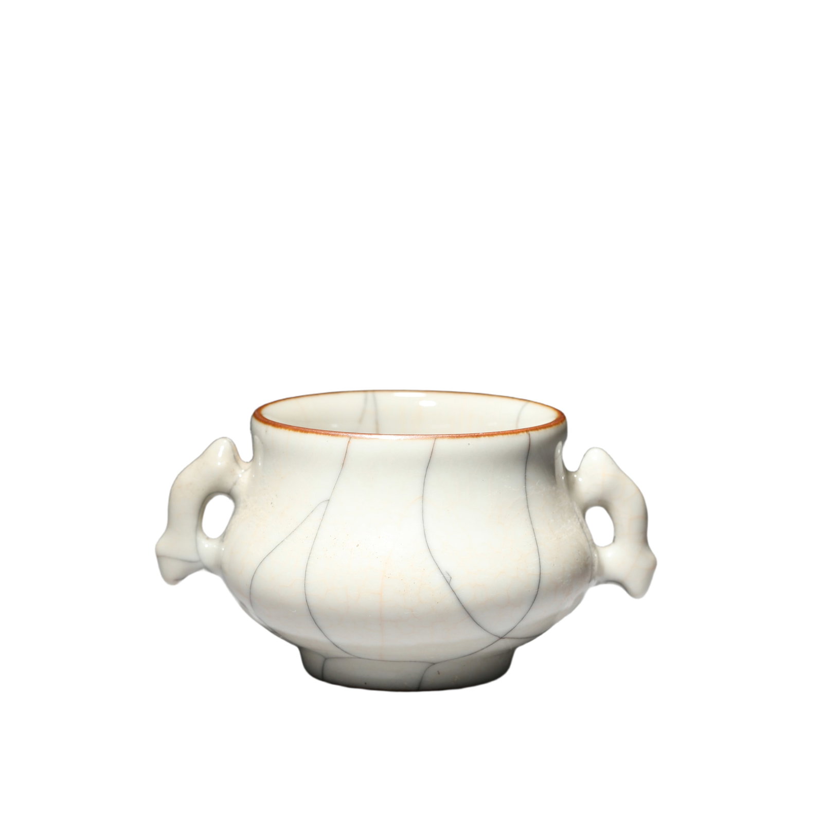 A GUAN-WARE CRACKLED CENSER: A GUAN-WARE CRACKLED CENSER Of compressed ovoid shape, flanked with pair handles by sides, covered overall with a pale glaze suffused with a network of golden and black crackles. DIMENSION: H:5.6cm; D