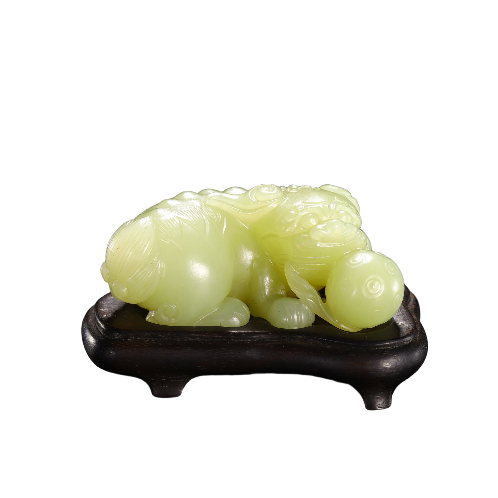 A CARVED YELLOW JADE BUDDHIST LION: A CARVED YELLOW JADE BUDDHIST LION Based on Qing court archival records, Emperor Qianlong had exacting aesthetic standards in relation to scholar items made of yellow jade. He preferred a plain elegan