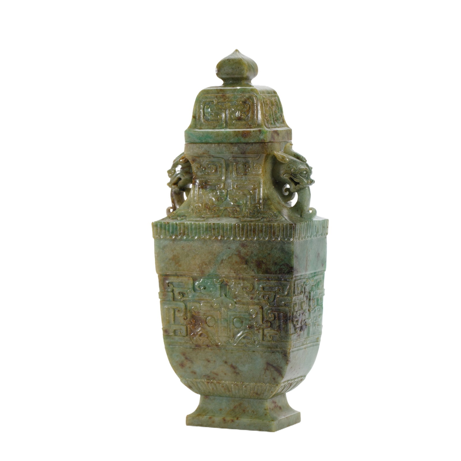 A CARVED JADEITE VASE WITH COVER: A CARVED JADEITE VASE WITH COVER Of flatten baluster shape, flanked with pair beast head handles, surmounted on a dome cover ended with bud finial. DIMENSION: L. 10 cm. W. 5 cm. H. 24 cm. Weight 900 g