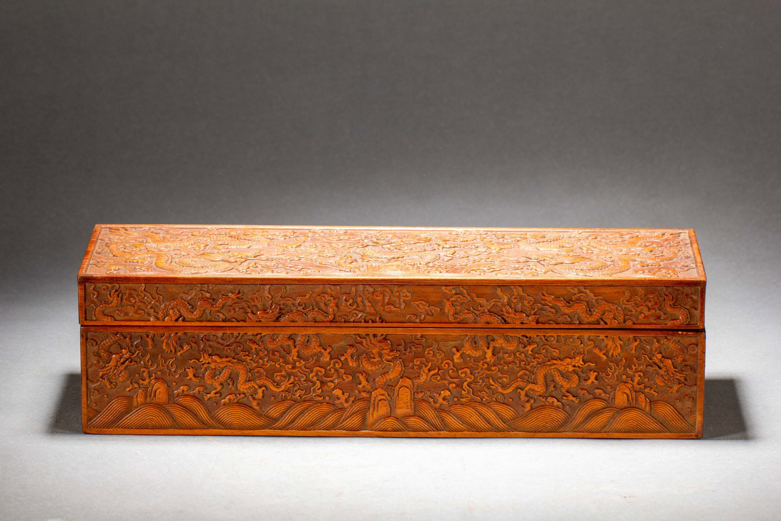 A CARVED HUANGHUALI LITERATI BOX WITH COVER: A CARVED HUANGHUALI LITERATI BOX WITH COVER Carved by huanghuali, showing off the extravagance of wealth to the most refined but subtle detail. DIMENSION: L. 40 cm. W. 13 cm. H. 11 cm. Weight 1560 gra