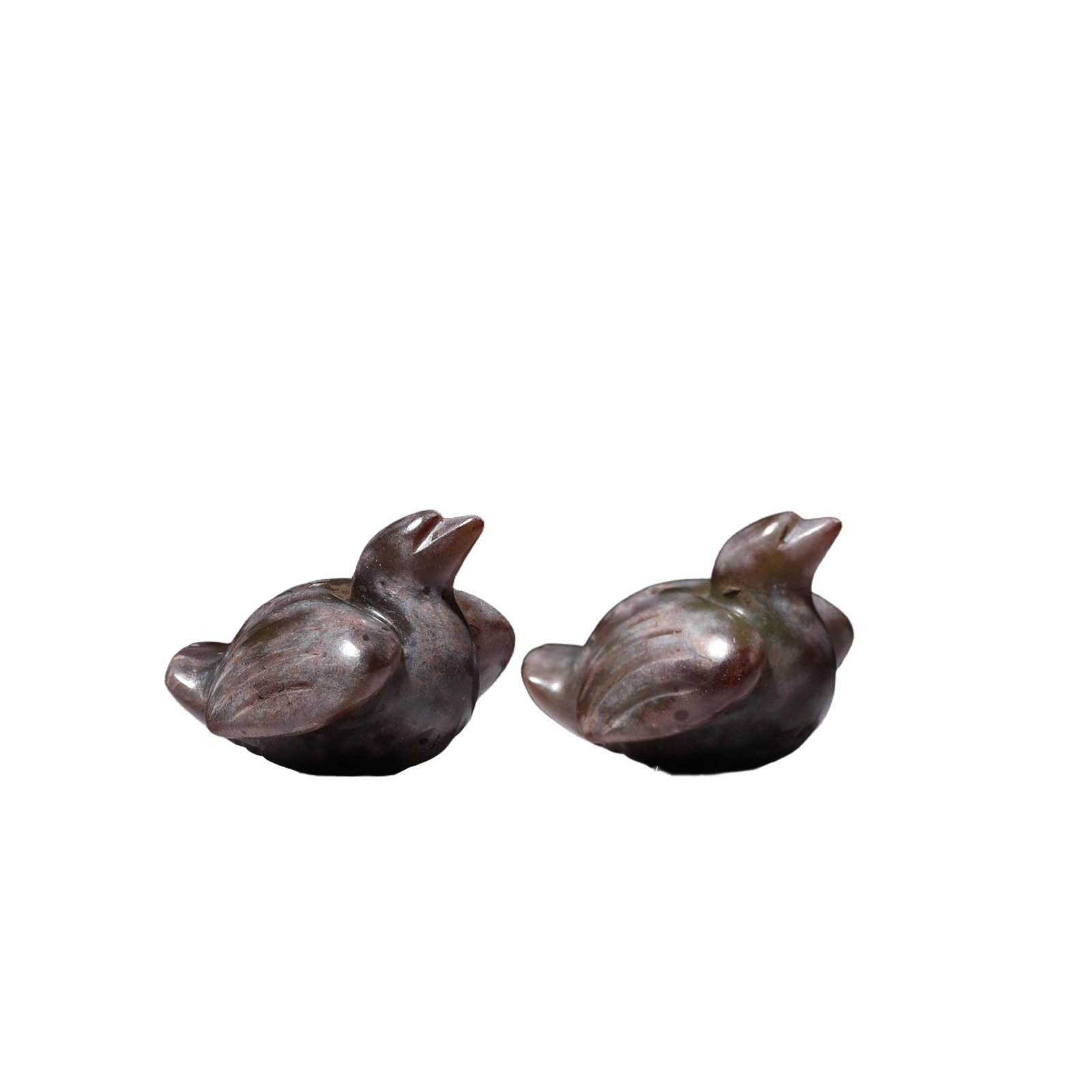 PAIR JADE CARVING OF MYTHICAL BIRDS: PAIR JADE CARVING OF MYTHICAL BIRDS The bird with trefoil crest and curved beak is shown in a recumbent position, with the tail feathers neatly fanned and the legs tucked beneath the body. DIMENSION:
