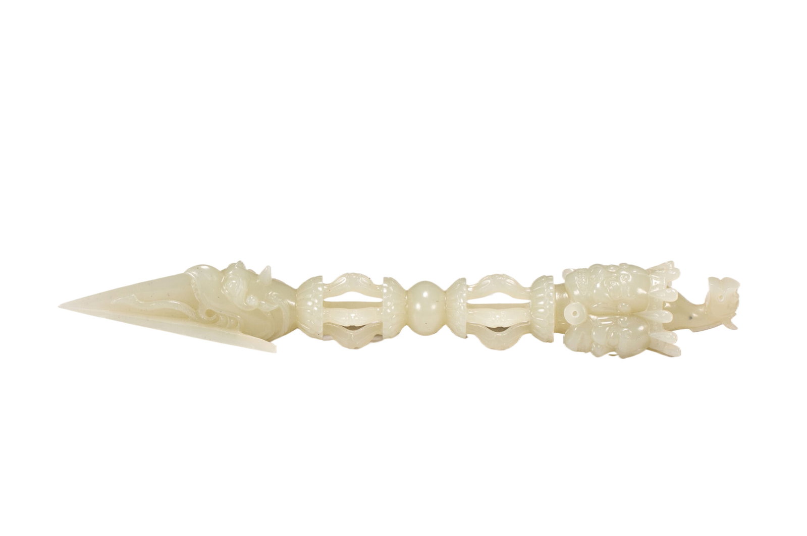 A FINE AND RARE CARVED WHITE JADE PHURBA: A FINE AND RARE CARVED WHITE JADE PHURBA The faces at the finial surmounted by a single chignon above stylized endless knots and lotus petals and aligned with each of the peg?s three sharp edges, with