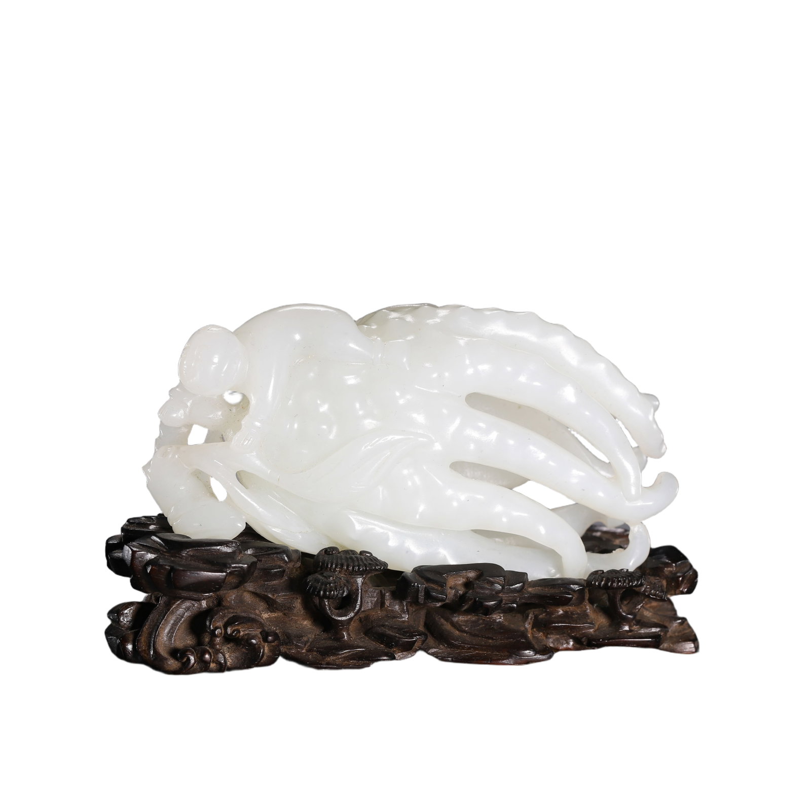A FINE CARVED WHITE JADE FINGERED CITRON: A FINE CARVED WHITE JADE FINGERED CITRON Realistically carved as a large citron with eleven curling 'fingers' issuing from an openwork leafy branch, a smaller fruit and large leaves providing support 