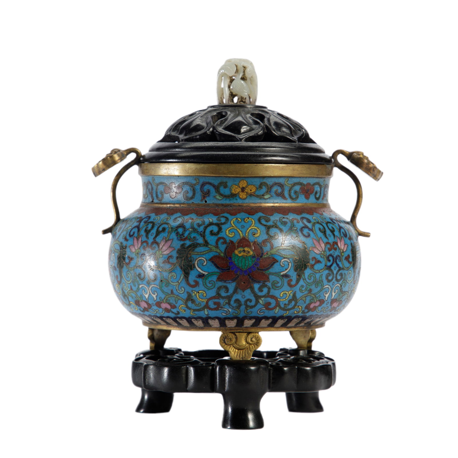 A CLOISONNE ENAMEL TRIPOD CENSER: A CLOISONNE ENAMEL TRIPOD CENSER The vessel supported on three short ruyi head feet, surmounted on a carved wooden cover ended with white jade finial. DIMENSION: L. 12 cm. W. 12 cm. H. 16 cm. Weight 1