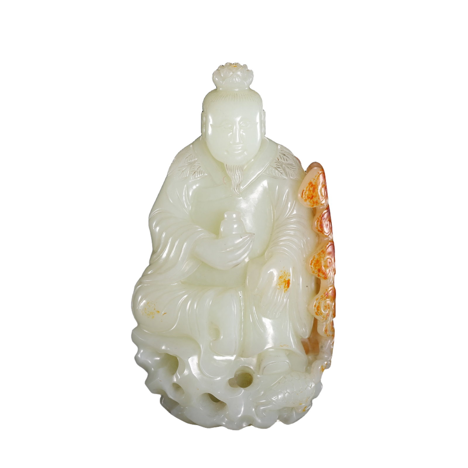 A CARVED WHITE JADE IMMORTAL: A CARVED WHITE JADE IMMORTAL An immoral shown seated with his left hand resting on his bent left knee. He wears loose robes draped over frame. His face, with contemplative expression, the stone is of 
