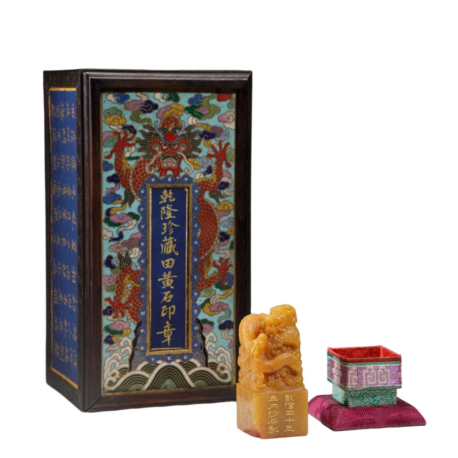 A CARVED TIANHUANG DRAGON SEAL: A CARVED TIANHUANG DRAGON SEAL Of squared shape, surmounted with coiled dragon as finial, the stone is of amber tone, with matched box and cover. DIMENSION: L. 3 cm. W. 3 cm. H. 6.8 cm. Weight 845 gra