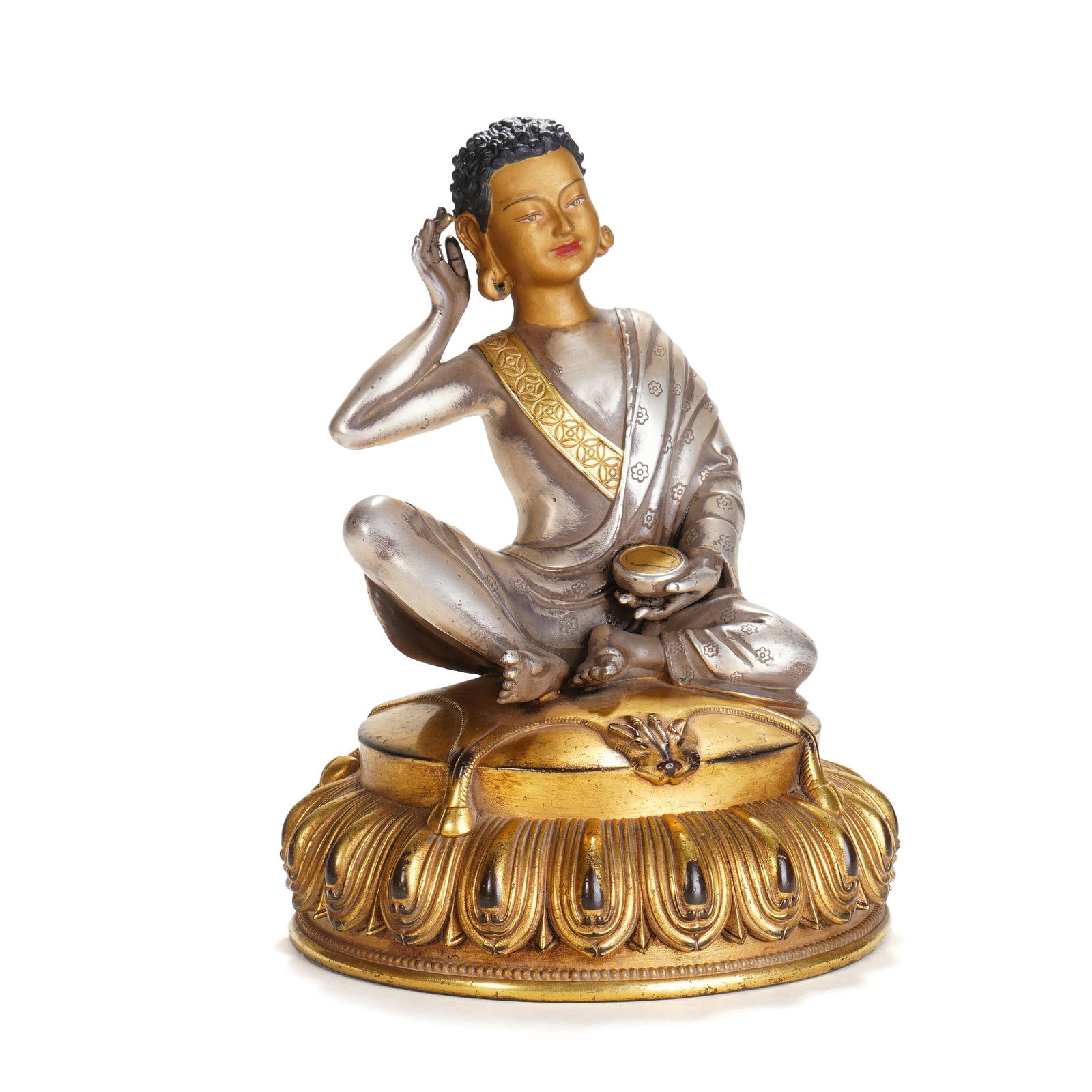 A BRONZE PARTLY GILT MILAREPA: A BRONZE PARTLY GILT MILAREPA Milarepa sits here in his most recognizable pose, with his right hand cupped behind his ear, identifies him as the Buddhist saint, Milarepa, whose melodious enlightened v