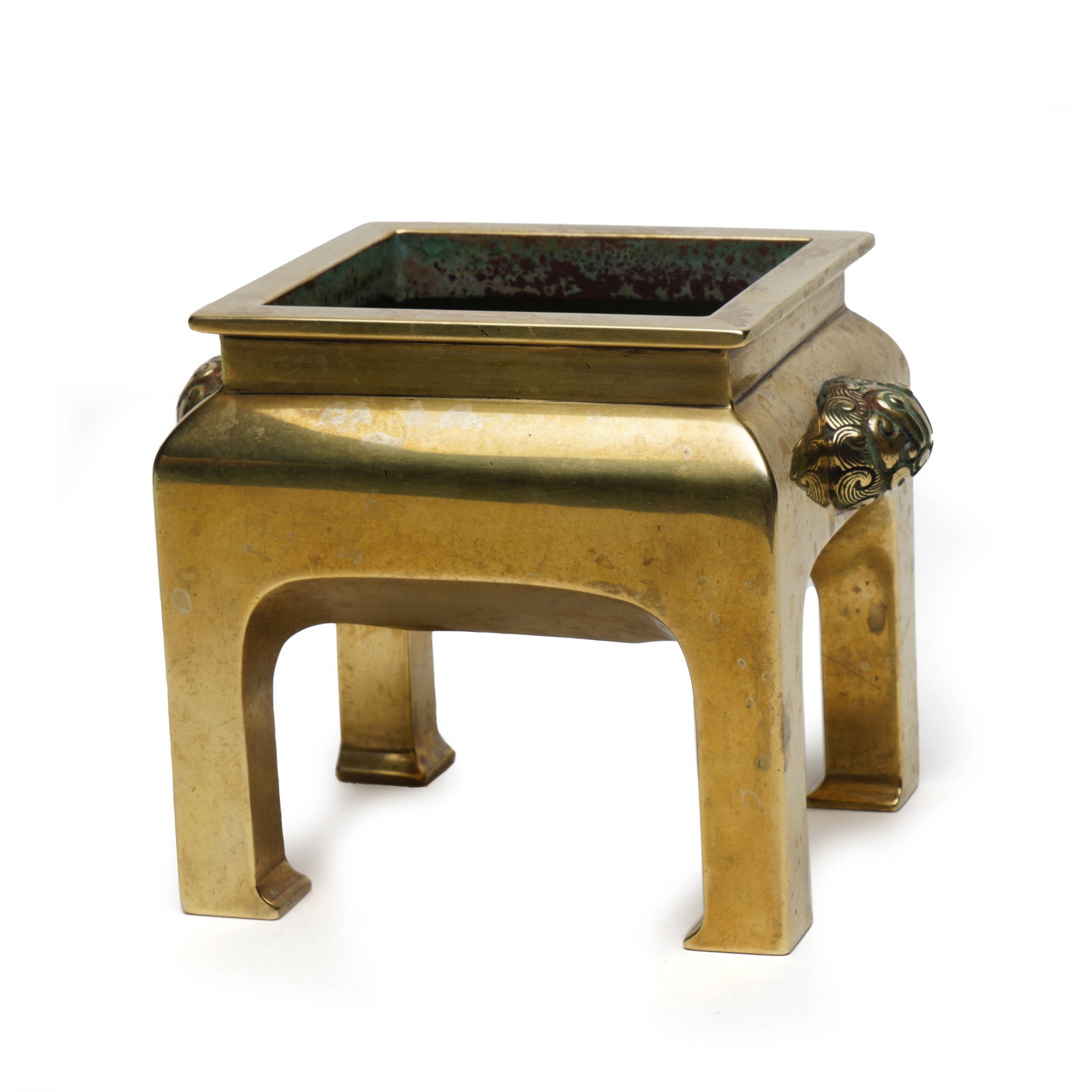 A BRONZE-GILT INCENSE BURNER: A BRONZE-GILT INCENSE BURNER The rectangular vessel supported on four legs, two makara head handles flanked on the sides, richly gilt. DIMENSION: HEIGHT: 11cm WIDE: 15cm A LIST OF RECOMMENDED