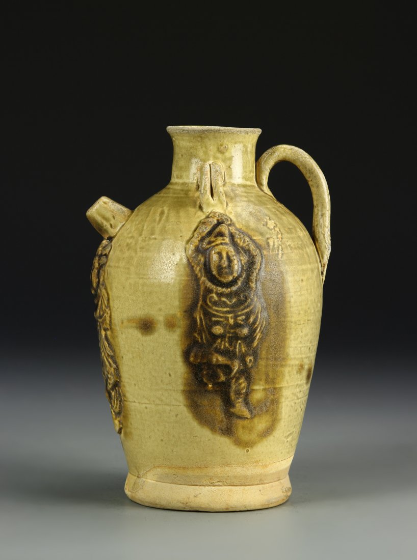 China, Tang dynasty, Yue Yao Ewer: China, Tang dynasty, Yue Yao Ewer, short neck and spout with handle at wide shoulders, flat base, grainy brown glaze throughout with darker decoration of maiko dancing with accompanist. Height 7 1/2 i