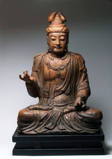 A Large Chinese Wooden Carving Of GuanYin: A Chinese Wooden Carving Of GuanYin 18th/19th C.This is a large painted wooden bodhisattva seated in the full lotus position with his hands held in the "peace" mudra. He wears flowing robes with a flo