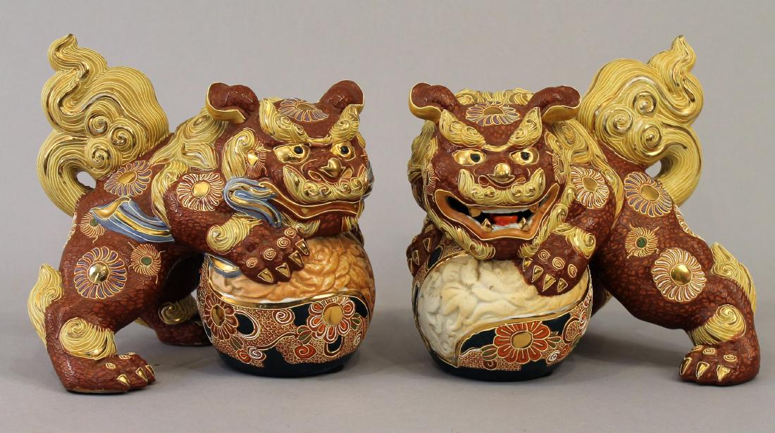 Pair of Foo Dogs: Pair of foo Dogs leaning against ball with red background with floral design. Mark on bottom. 8" tall x 9" long, 8" deep.