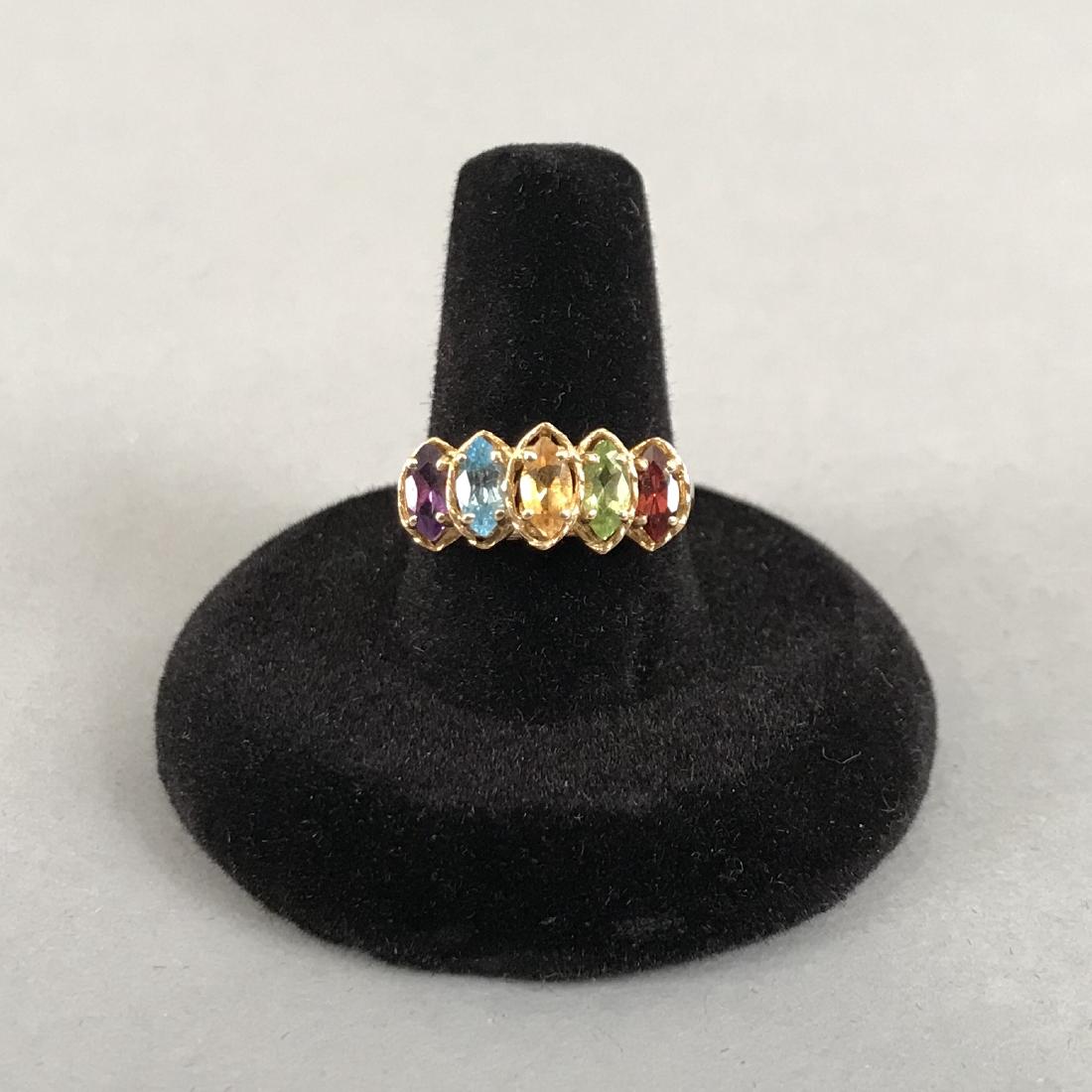 10K Gold Multi Colored Gemstone Ring: 10K gold ring with cat eye shaped Amethyst, Saphire, Citrine, Peridot & Garnet gemstones. Marked 10K, the letter R in a circle and what looks like 94. Size 8.25. Gross weight 2.7g. Shipping available 