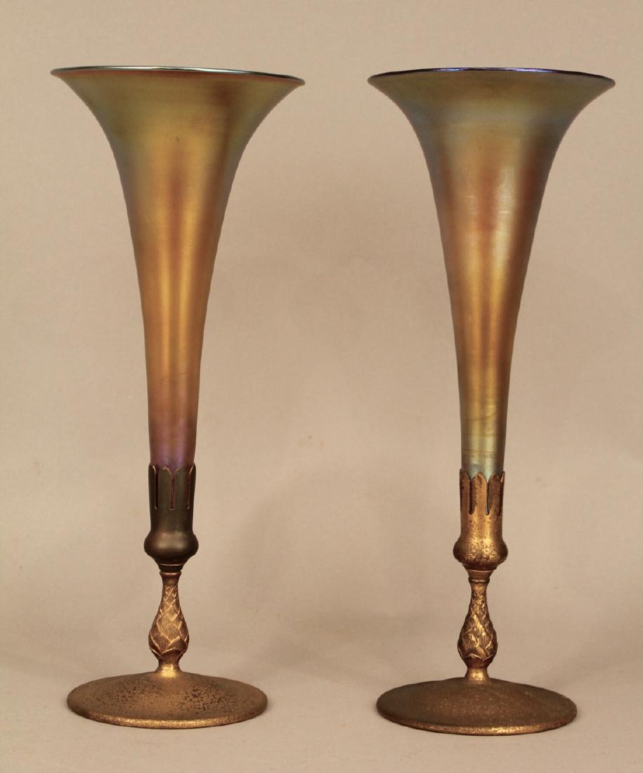 Pr Louis Comfort Tiffany Favrille Trumpet Vases: Pair of Louis Comfort Tiffany Favrille Glass Trumpet Vases with irridescent glass tops set in bronze bases. Glass trumpets marked LCT Favrille. Base marked Tiffany Studios New York 1668. 15 3/4"H