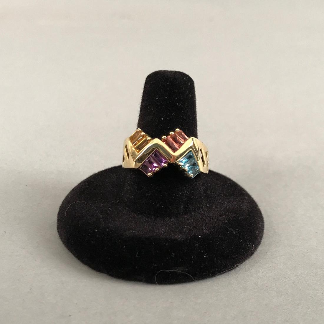 14K Gold Ring with a Rainbow of Gemstones: 14K Gold Ring with a Rainbow of Gemstones. Blue Topaz,Pink Saphire, Amethyst, Citrine. Marked 14K with stylized SNB in an oval. Size 9. Gross weight 6.4g. Shipping available within the continental Uni