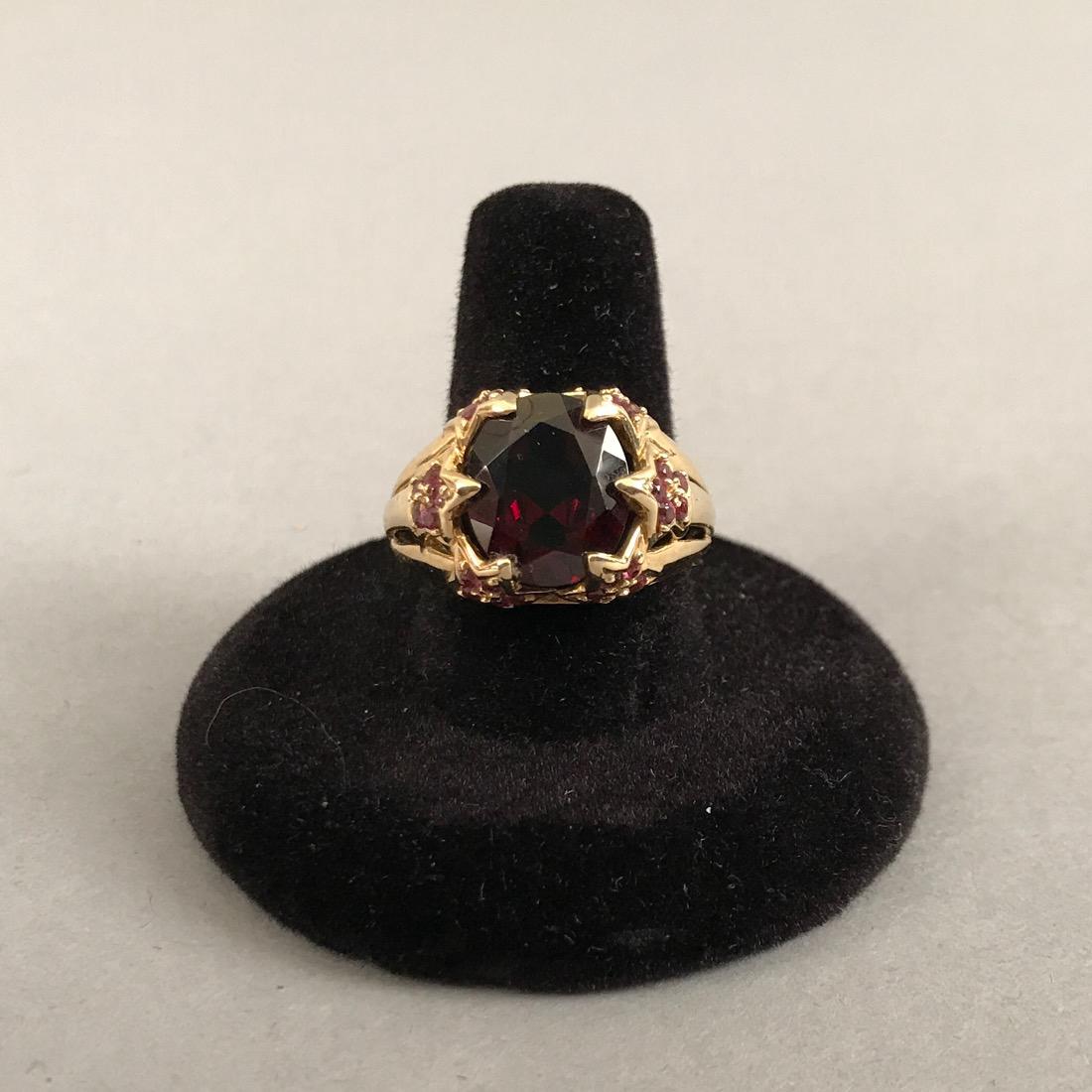 14K Gold Ring with Garnet & Amethyst: 14K gold ring with garnet center stone. Center stone is surrounded by small stars made up of small amethysts. Marked 14K Thailand. Size 9. Gross weight 5.3g. Shipping available within the continental 