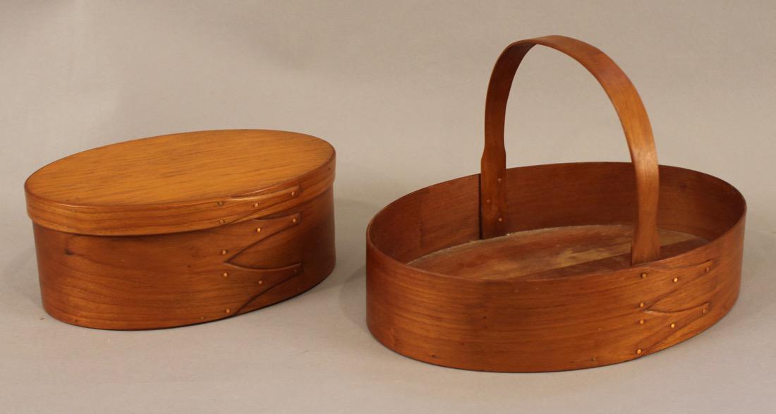 Two Vintage Oval Fingered Shaker Boxes: Two Vintage Shaker Boxes. One handled sewing box,one lidded pantry box. Sewing box 7"H x 11"W x 8"D Pantry box 3 3/4"H x 9"W x 6 1/2"D