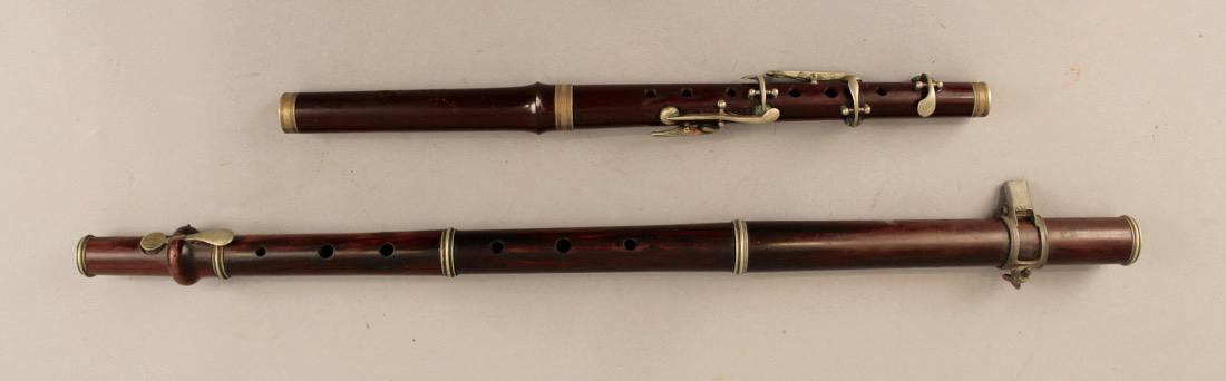 2 Piccolos One Rosewood and One Walnut: 2 Piccolos, One Rosewood and One Walnut. Smaller walnut one marked parade model J.W.S.L. with a crown above. Larger rosewood one unmarked. Smaller 14 3/4" Larger 23 1/4"