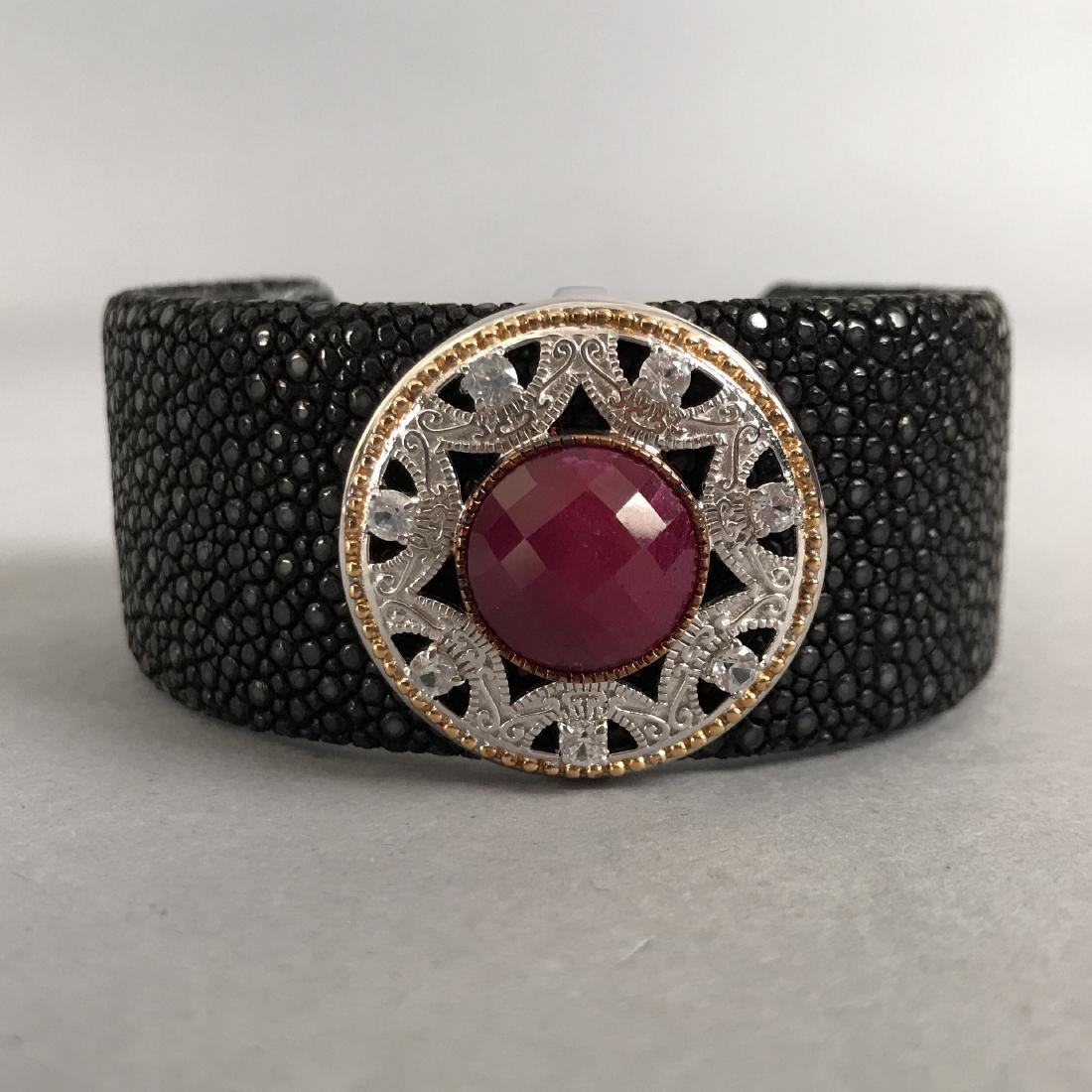 Stingray Cuff w/ Sterling Silver Gemstone Accent: Stingray cuff bracelet with Sterling silver enhancer. Enhancer has large checkerboard cut mahalo ruby surrounded by diamonds. Marked NF 925 Thailand. Shipping available within the continental United S