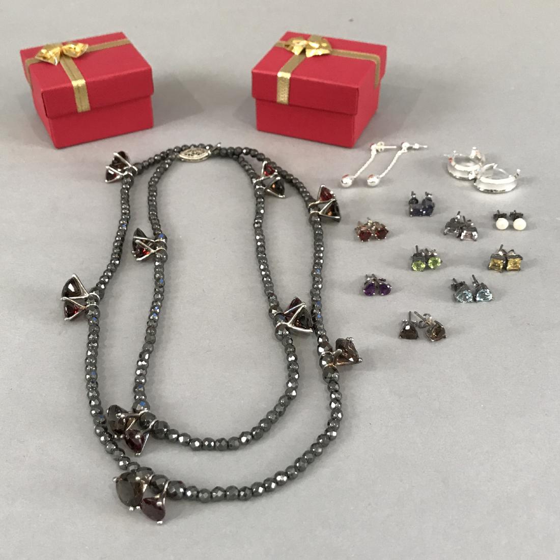 12 Pcs Sterling Silver 11 pr Earrings 1 Necklace: 11 pairs of sterling silver earrings, most with assorted gemstones. One necklace with sterling silver, garnet, cagnac citrine and hematite.