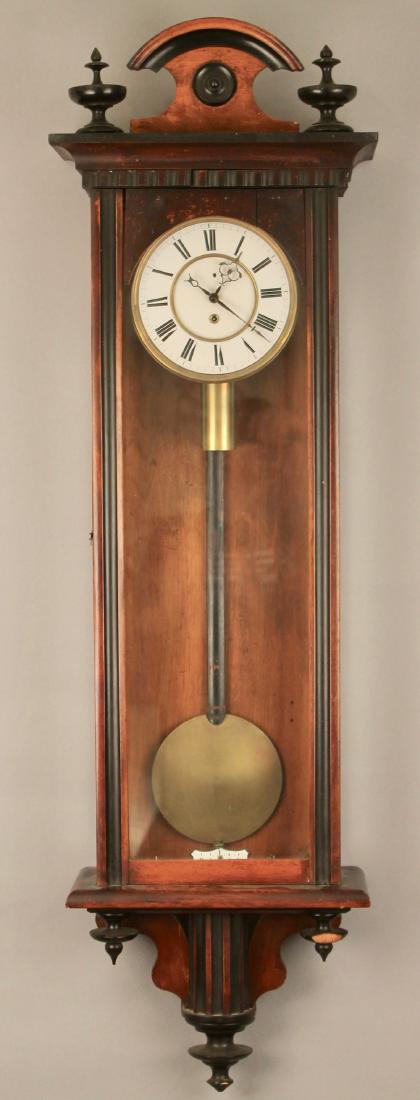 Walnut and Ebony Wall Clock: Walnut and Ebony Wall Clock with porcelain face and brass. 45" x 13 1/2" x 6"